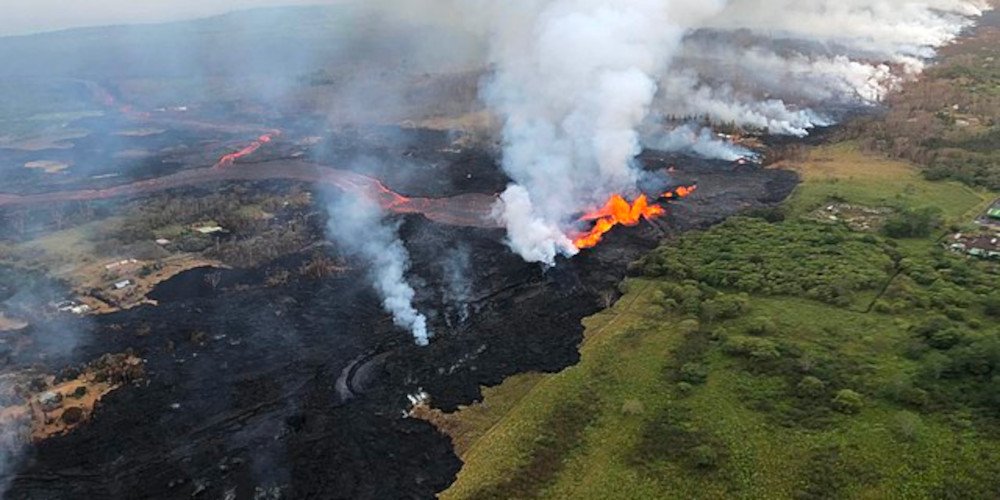 lava creeping across a forest landscape, burning vegetation and making smoke